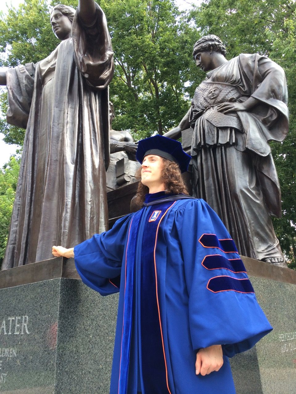 Brendon Smith in doctoral regalia after defending dissertation