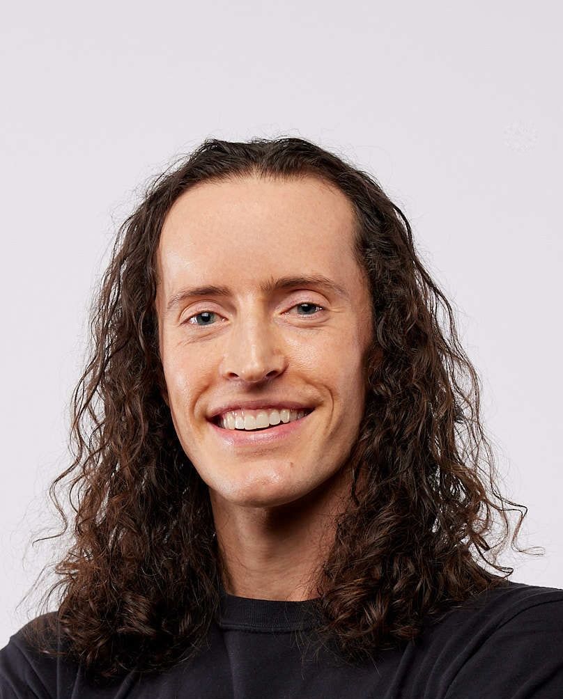 Portrait of Brendon Smith smiling in a black t-shirt