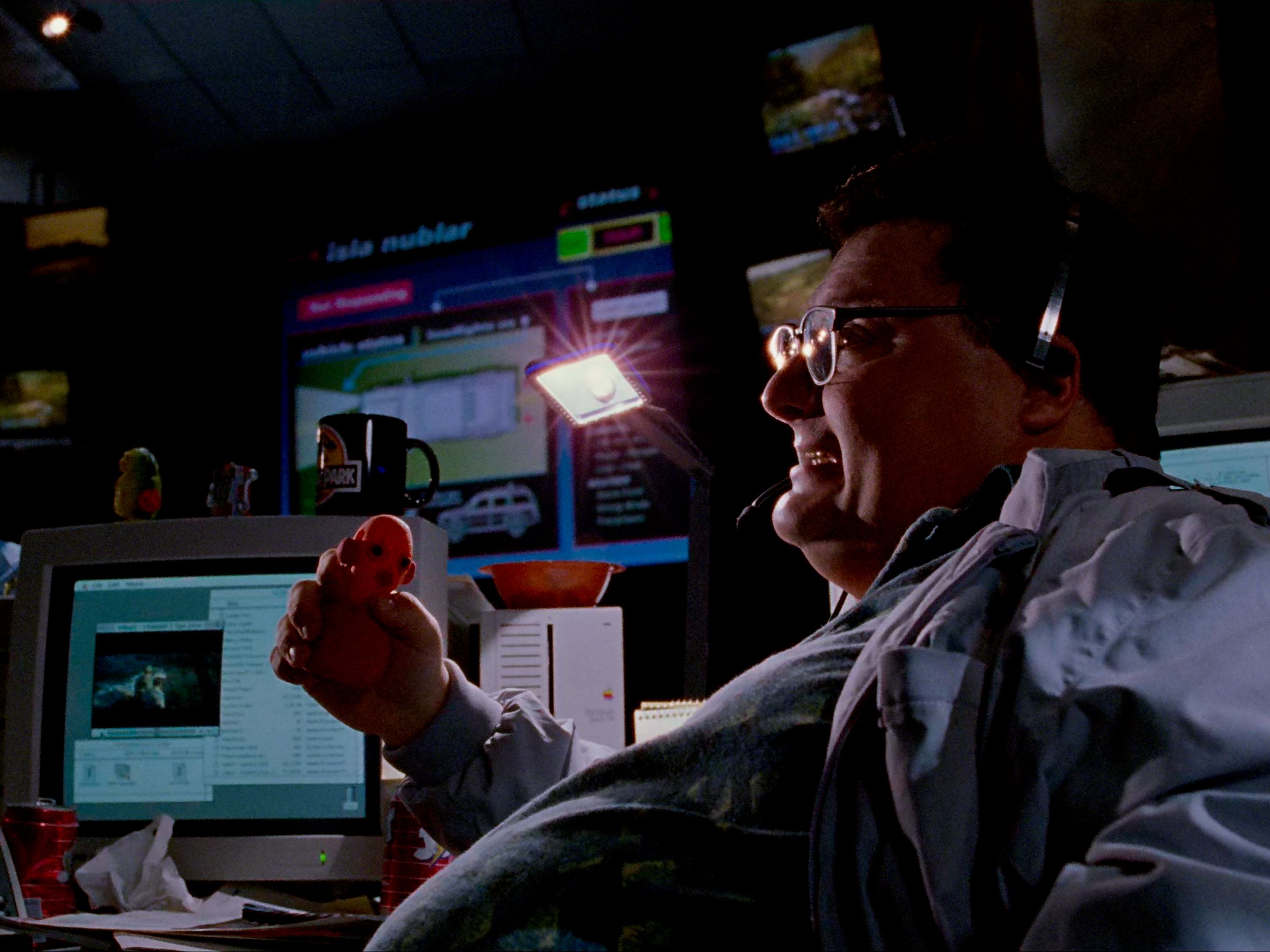 Image from Jurassic Park (1993) of Dennis Nedry (Wayne Knight) squeezing a stress ball and saying, 'Thanks, Dad.'